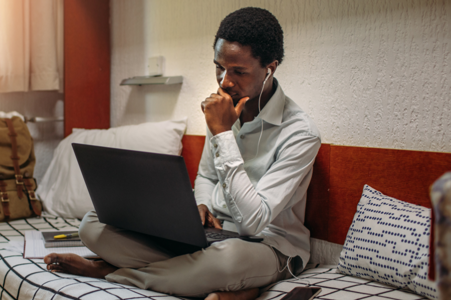 photo of college student using laptop for online learning at home