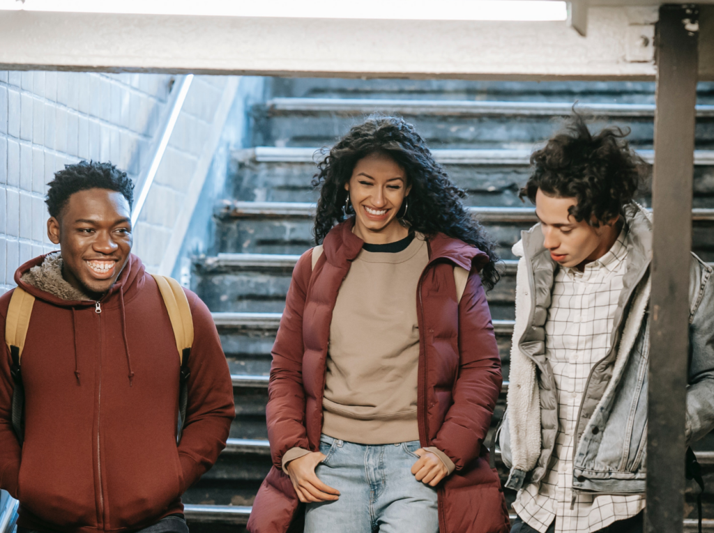 Photo of smiling students using public transit to commute to school