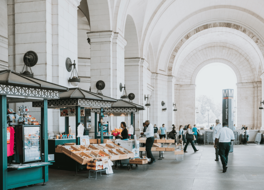 people at kiosks in front of Union Station