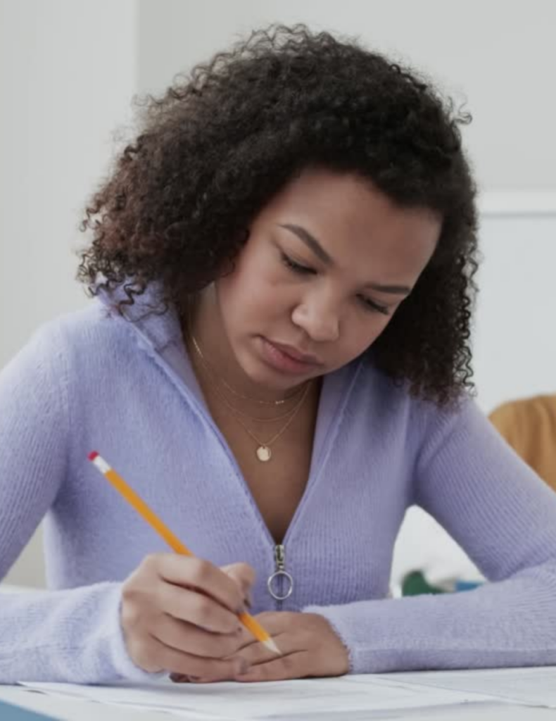 photo of student taking an exam in a classroom