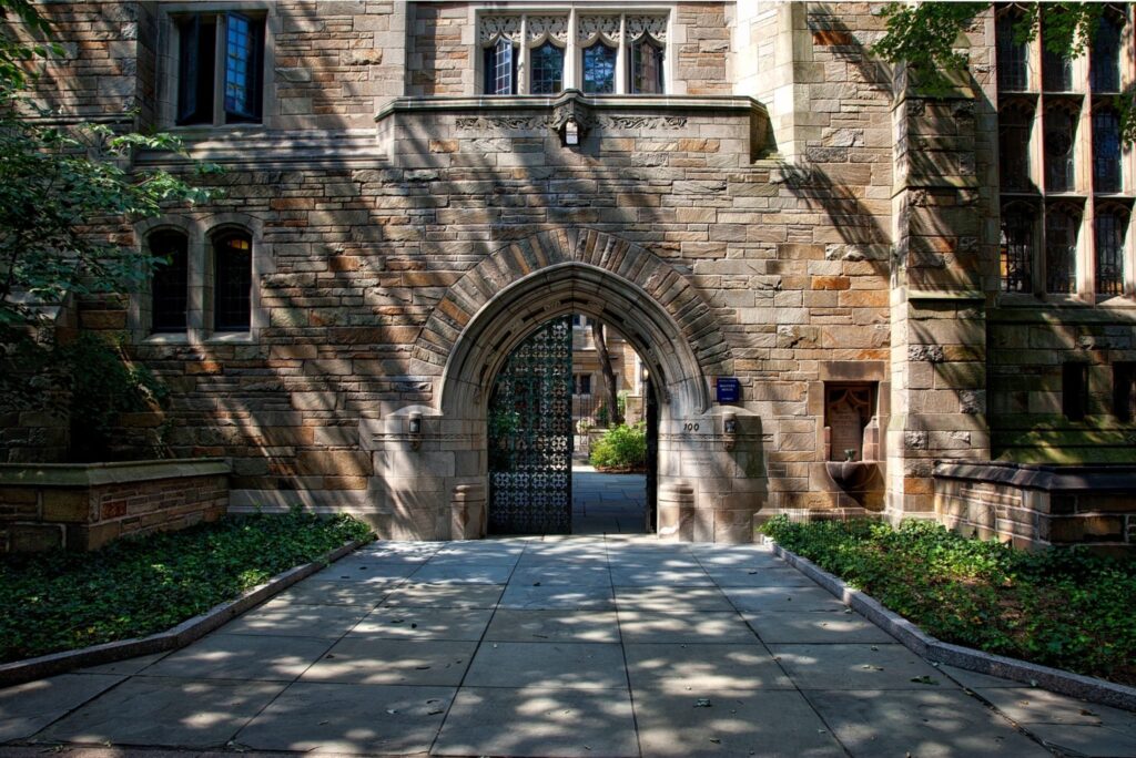 brick building with open metal gate leading to the inner courtyard