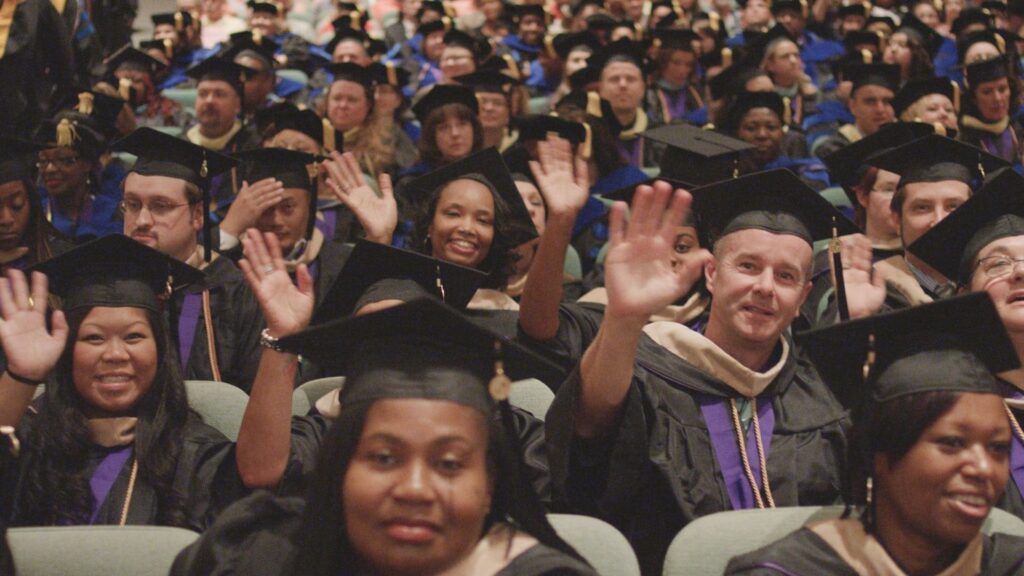 Crowd of grads waving