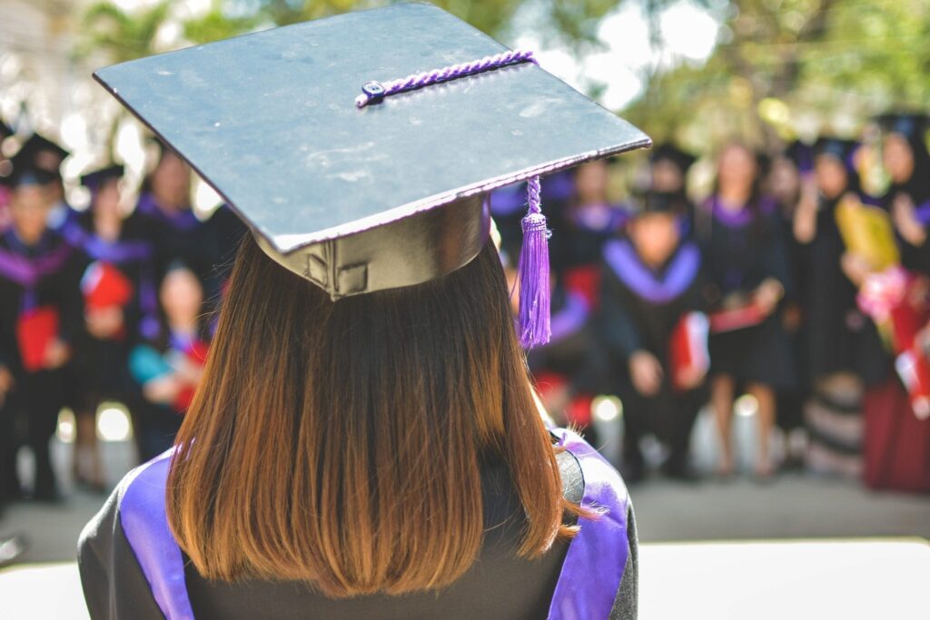 Female Grad addressing fellow Grad class