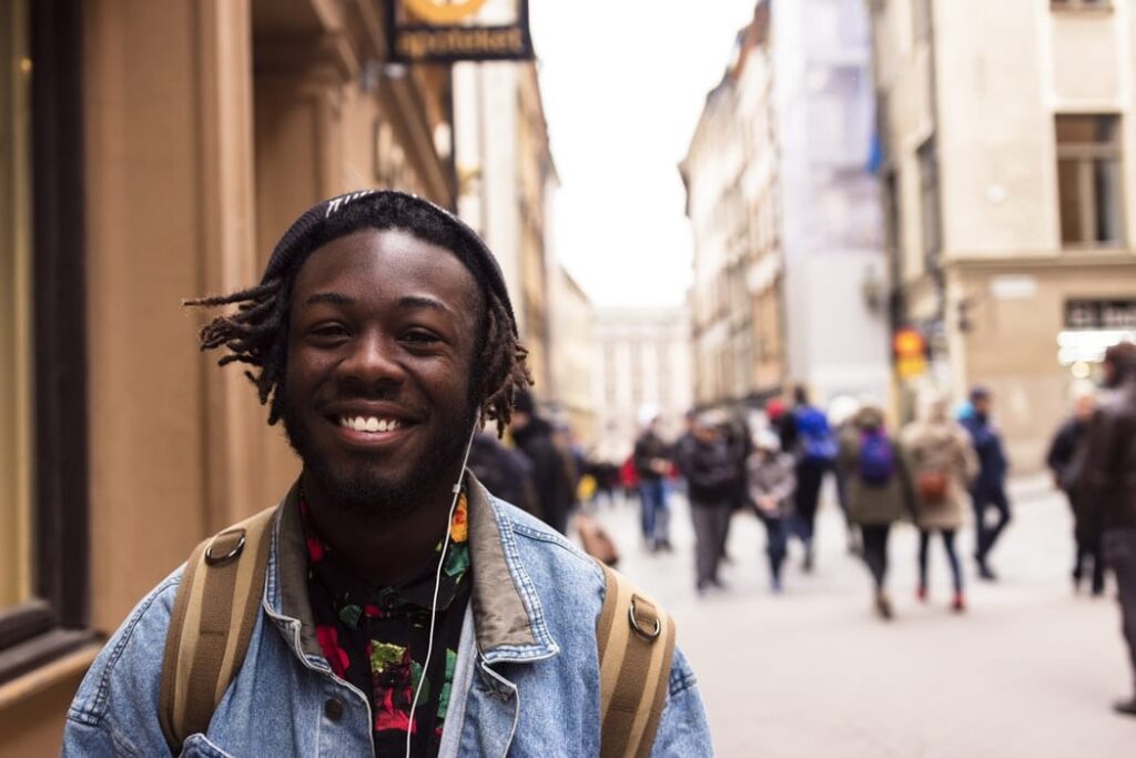 happy student smile walking down the street while listening to music