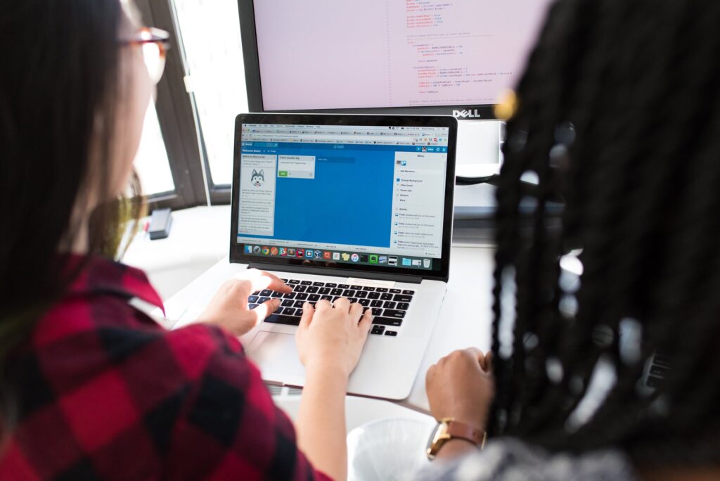 two people using a laptop