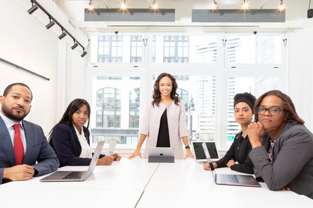 people at a meeting looking into the camera