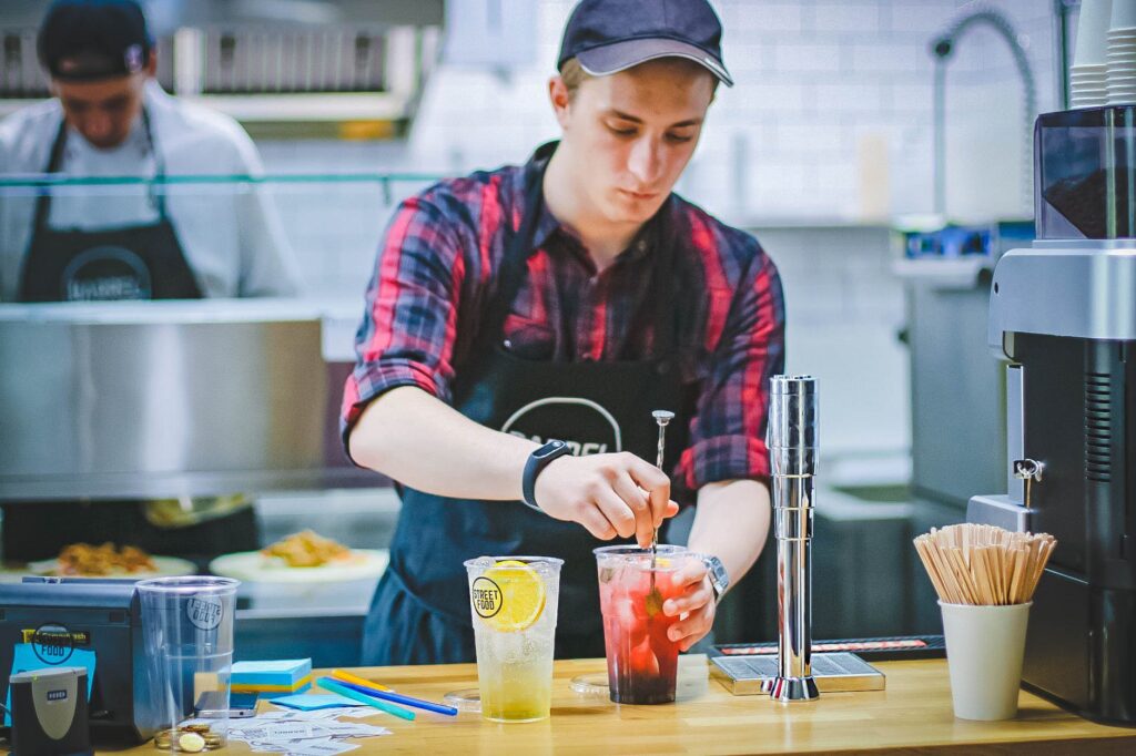 cafe worker mixing drinks