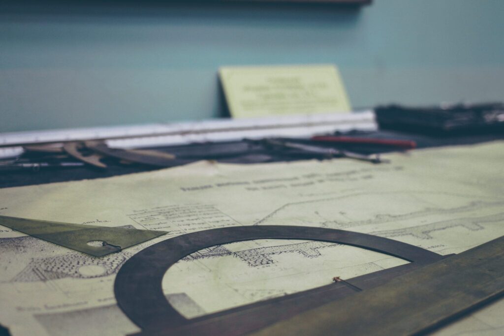 Blueprint with protractors and rulers on desk