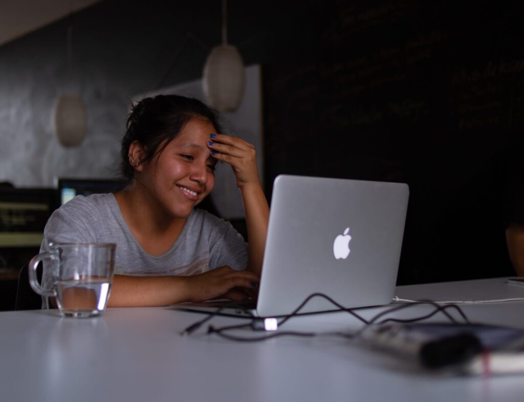 student laughing at the laptop screen